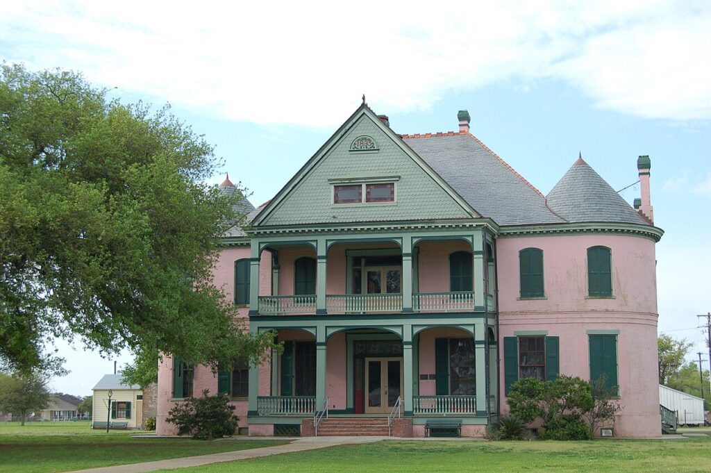 Southdown Plantation pink brick house with green shutters